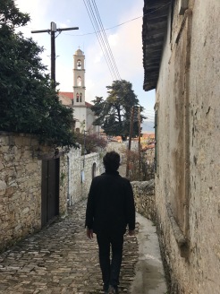 Man walking in a narrow street in Lofou Cyprus